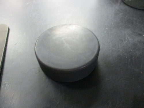 Used Black Rubber Hockey Puck