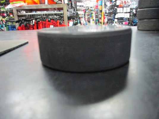 Used Black Rubber Hockey Puck