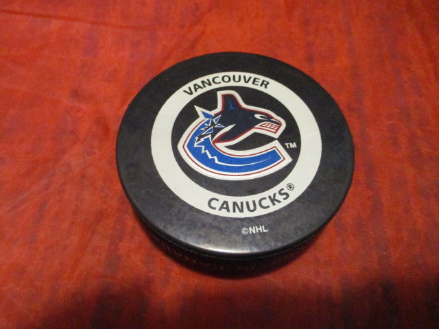 Load image into Gallery viewer, Used Vancouver Canucks NHL Official Game Hockey Puck
